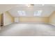 Spacious bonus room with vaulted ceilings, skylights, and neutral carpet flooring at 1545 Chadmore Nw Ln, Concord, NC 28027