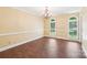 Formal dining room with wood floors, chandelier, and bright windows with shutters overlooking the landscaped yard at 1545 Chadmore Nw Ln, Concord, NC 28027