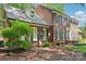 Side angle of a lovely two-story brick home featuring blue shutters and well-maintained landscaping at 1545 Chadmore Nw Ln, Concord, NC 28027
