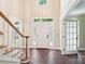 Grand foyer with dark hardwood floors, staircase and a front door with decorative glass at 1545 Chadmore Nw Ln, Concord, NC 28027