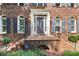 Inviting front entrance with brick steps, black railings and a classic door with sidelights at 1545 Chadmore Nw Ln, Concord, NC 28027
