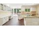 Sunlit kitchen featuring granite counters, wood floors, white cabinets, island cooktop, and eat-in area at 1545 Chadmore Nw Ln, Concord, NC 28027