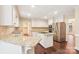 Updated kitchen featuring white cabinetry, granite countertops, stainless steel appliances, and wood floors at 1545 Chadmore Nw Ln, Concord, NC 28027