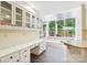 Kitchen with eat-in area, granite counters, wood floors, white cabinets, and custom glass faced cabinets at 1545 Chadmore Nw Ln, Concord, NC 28027