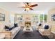 Bright, staged living room with a fireplace, plush seating, and large windows at 1545 Chadmore Nw Ln, Concord, NC 28027