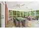 Inviting sunroom with ceiling fans, tiled floors, dining table, and comfortable seating at 1545 Chadmore Nw Ln, Concord, NC 28027