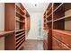 Spacious walk-in closet with custom shelves, drawers, and wood flooring for maximum storage and organization at 1545 Chadmore Nw Ln, Concord, NC 28027