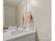 Bright half-bath featuring a modern vanity and decorative accents at 19010 Oakhurst Blvd, Cornelius, NC 28031