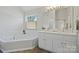 Bathroom featuring double vanity, bath tub, and shower at 19010 Oakhurst Blvd, Cornelius, NC 28031