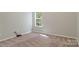 Neutral bedroom featuring neutral carpet and a window at 19010 Oakhurst Blvd, Cornelius, NC 28031