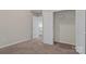 Bright bedroom with neutral walls, plush carpeting, and a closet for ample storage at 19010 Oakhurst Blvd, Cornelius, NC 28031