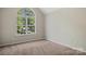Bright bedroom featuring a large window providing natural light and views at 19010 Oakhurst Blvd, Cornelius, NC 28031