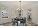 Charming dining room with dark wood table, gray chairs, and view to the kitchen at 19010 Oakhurst Blvd, Cornelius, NC 28031
