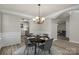Elegant dining room with chandelier, space for four, and archway to living space at 19010 Oakhurst Blvd, Cornelius, NC 28031