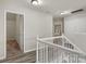 Upstairs hallway featuring hardwood floors and access to bedrooms and storage at 19010 Oakhurst Blvd, Cornelius, NC 28031