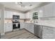 Bright kitchen with stainless steel appliances, light countertops, and white cabinetry at 19010 Oakhurst Blvd, Cornelius, NC 28031