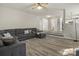 Open-concept living room showcasing hardwood floors and gray sectional sofa at 19010 Oakhurst Blvd, Cornelius, NC 28031