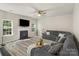 Spacious living room with fireplace, large windows, and gray sectional sofa at 19010 Oakhurst Blvd, Cornelius, NC 28031