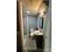 Bathroom with toilet, sink, mirror, and gray tile flooring at 2116 Dana Pl, Shelby, NC 28152