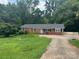 Charming one-story brick home with a well-maintained front lawn and a spacious driveway at 2116 Dana Pl, Shelby, NC 28152