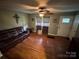 A cozy living room boasts hardwood floors, plenty of natural light, and a comfortable leather sofa at 2116 Dana Pl, Shelby, NC 28152