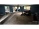 Spacious living room features neutral carpet, a ceiling fan, a leather couch, and ample natural light at 2116 Dana Pl, Shelby, NC 28152