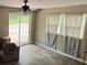The light-filled room boasts windows, and a sliding glass door that invites natural light, creating a bright and airy atmosphere at 2116 Dana Pl, Shelby, NC 28152