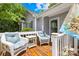Inviting front porch with white wicker chairs and a cozy seating area, adding curb appeal to the home at 2490 Hawk Ridge Dr, Gastonia, NC 28056