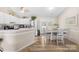 Bright eat-in kitchen features white cabinets, stainless steel appliances, and wood flooring at 2490 Hawk Ridge Dr, Gastonia, NC 28056