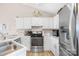 Updated kitchen boasts white cabinets, stainless steel appliances, and a modern range at 2490 Hawk Ridge Dr, Gastonia, NC 28056