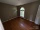 Cozy bedroom with hardwood floors and a unique arched window at 2547 Nc 182 Hwy, Lincolnton, NC 28092