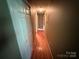 Long hallway with wood floors, connecting various rooms within the home at 2547 Nc 182 Hwy, Lincolnton, NC 28092