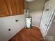 Practical laundry area with cabinets, water heater, and hardwood floors at 2547 Nc 182 Hwy, Lincolnton, NC 28092