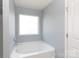 Bright bathroom showcases a soaking tub and natural light from the window at 2720 Watergarden St, York, SC 29745