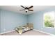 This cozy bedroom features a single window, fan, and neutral carpet at 2720 Watergarden St, York, SC 29745