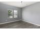 Serene bedroom showcasing neutral walls, wood floors and a bright window for an airy feel at 2720 Watergarden St, York, SC 29745