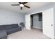 Cozy bonus room with a grey sofa, rocking chair, and ample closet space at 2720 Watergarden St, York, SC 29745