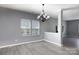 Bright dining area features gray walls, modern chandelier, and ample natural light from large windows at 2720 Watergarden St, York, SC 29745