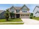 Charming two-story home featuring a two-car garage, well-manicured lawn, and inviting curb appeal at 2720 Watergarden St, York, SC 29745