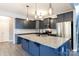 Modern kitchen featuring a large island, granite countertops, stainless steel appliances, and stylish pendant lighting at 2720 Watergarden St, York, SC 29745