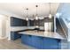 Modern kitchen featuring a large island, granite countertops, stainless steel appliances, and stylish pendant lighting at 2720 Watergarden St, York, SC 29745