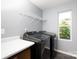 Modern laundry room with machines and storage space at 2720 Watergarden St, York, SC 29745