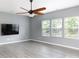 Spacious living room with stylish wood floors, three bright windows, and a mounted TV at 2720 Watergarden St, York, SC 29745