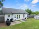 Fenced backyard featuring well-maintained lawn, patio seating, above ground pool and grill at 301 Rowan Gq St, Salisbury, NC 28146