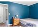 Bedroom features a calming blue painted wall with a three drawer dresser, bed and nightstand at 301 Rowan Gq St, Salisbury, NC 28146