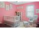 Sweet pink Bedroom with crib, rocker, and decorative accents creating a cozy and welcoming space at 301 Rowan Gq St, Salisbury, NC 28146