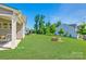 Well-manicured back yard featuring a fire pit and ample green space perfect for outdoor activities at 3041 Winged Teal Ct, Belmont, NC 28012