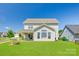 Picture of a well-maintained backyard with a fire pit, grassy area, and a view of the home's exterior at 3041 Winged Teal Ct, Belmont, NC 28012