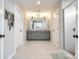 Bright bathroom featuring double sinks, a large mirror, and a modern walk-in shower at 3041 Winged Teal Ct, Belmont, NC 28012