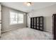 This bedroom has neutral gray walls, large windows, carpet flooring, and a dark wood bookcase at 3041 Winged Teal Ct, Belmont, NC 28012
